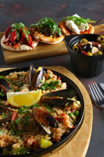 Set of tapas and paella with shrimps and mussels