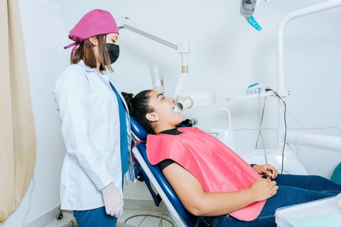 Intraoral radiography concept. Dentist doing intraoral dental x-ray to patient