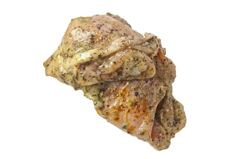 Raw piece of chicken with spice and sauce prepered for barbecue. Gastronomy template isolated on white background