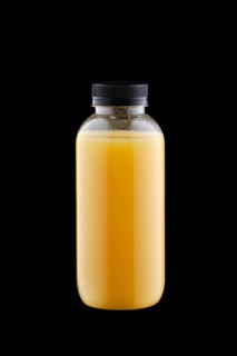 Plastic bottle with orange juice isolated on black