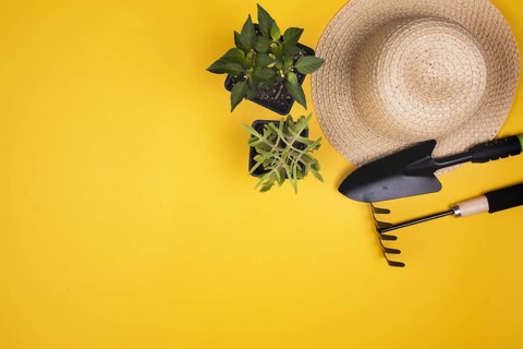 Gardening tools with straw hat copy space