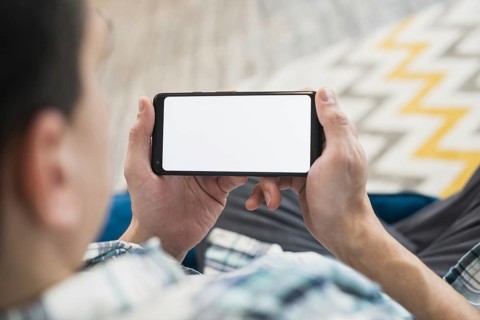 Man looking smartphone settee
