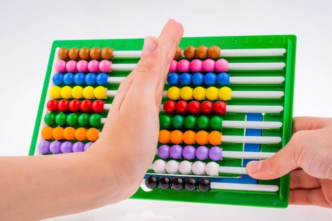 Hand using a color abacus