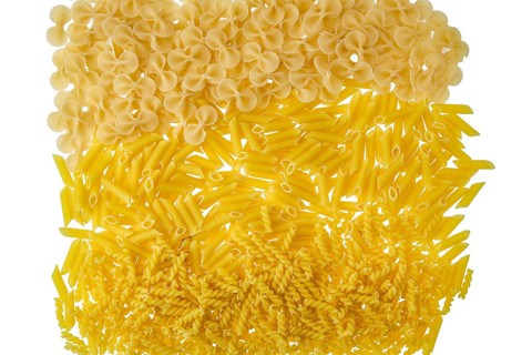 Overhead view of various kinds of pasta isolated on white background