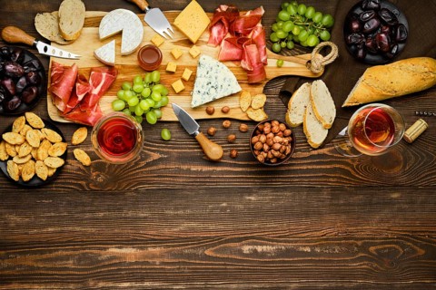 Top view of cheese plate with prosciutto