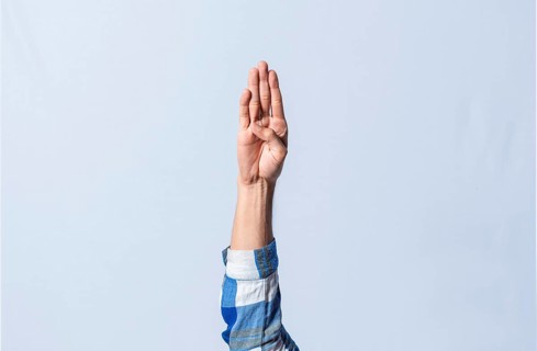 Hand gesturing the letter B in sign language on isolated background. Man hand gesturing the letter B of the alphabet isolated. Letters of the alphabet in sign language