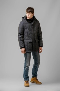 Full length portrait of handsome man in warm winter coat posing in studio