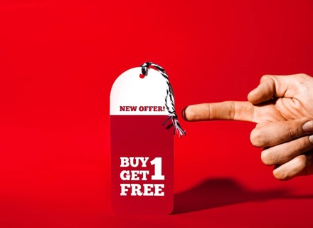 Hand showing tablet with new offer inscription