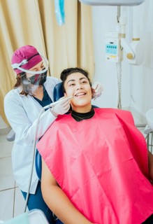 Stomatologist cleaning a patient teeth