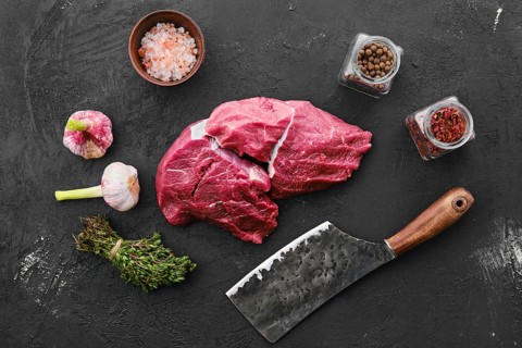 Raw fresh beef chuck eye roast on black background