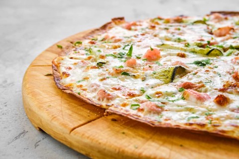 Thin-crust pizza dough with shrimps and zucchini