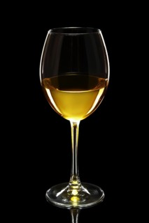 Glass of white wine isolated on black