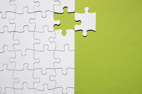 White puzzle piece separate with white puzzle grid green backdrop. Resolution and high quality beautiful photo