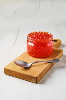 Open bowl with pink salmon red caviar
