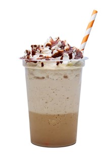 Cappuccino with whipped cream and syryp in take away plactic glass