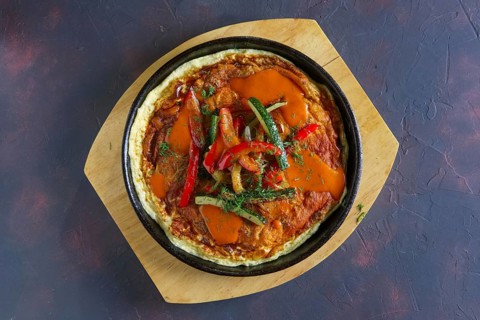 Top view of omelette with paprika and zucchini. Rural breakfast