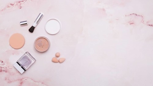 Face powder makeup brush powder puff bottle blender pink backdrop