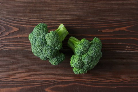 Broccoli on dark wooden background