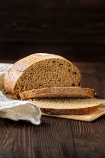 Rue brown bread on cutting board on the table
