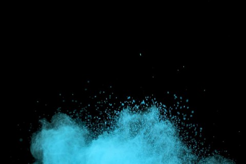 Flying blue colored dust particles