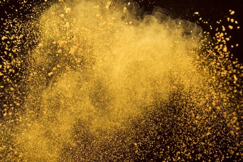 Orange explosion cosmetic powder dark background 1