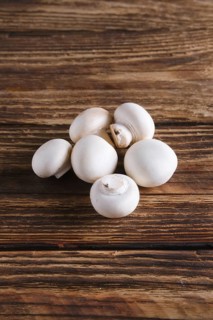 Fresh champignon on wooden background