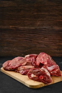 Assortment of raw fresh lamb meat on wooden tray