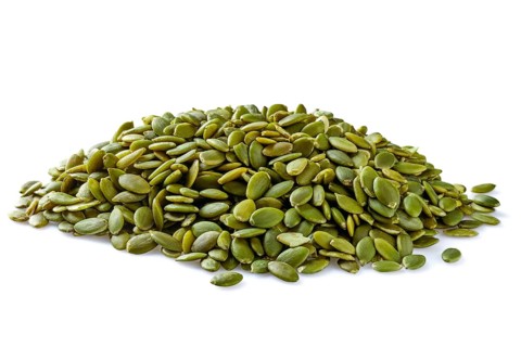 Heap of peeled pumpkin seeds isolated on white
