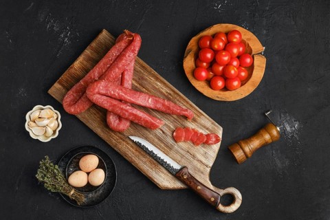 Air dried turkey sausage. Rustic lunch with eggs and tomato