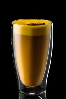 Double wall glass of hot chocolate with star anise isolated on black background