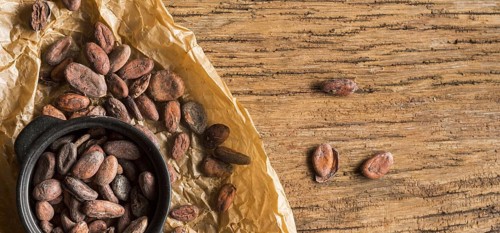 Flat lay cocoa beans pot