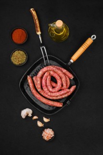 Top view of thin beef sausages on grill pan