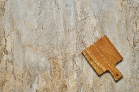 Top view of empty serving board on wooden background