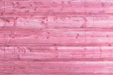 Pink wooden background with old painted planks