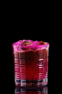 Espresso and tonic with pitaya syrup on black background