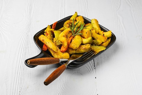 Spicy pumpkin and carrot baked in oven on ceramic plate