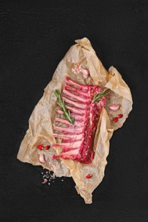 Overhead view of raw fresh rack of lamb in wrapping paper