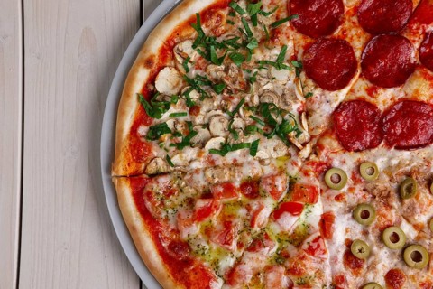 Top view of pizza four seasons. Copy-space place