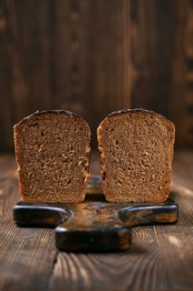Loaf of artisan rye bread cut on half