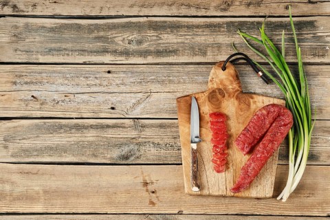 Top view of smoked dried turkey sausage on wooden cutting board