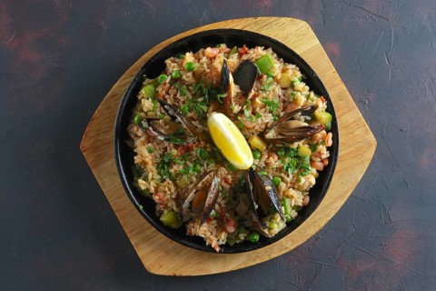 Top view of traditional spanish paela with shrimps and mussels
