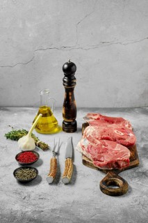 Raw lamb leg cut as a steak. Slices of shank on cutting board
