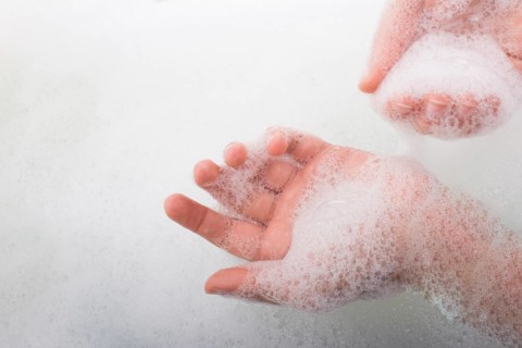 Hand washing and soap foam on a foamy background