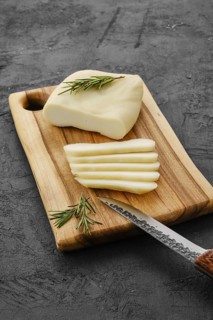 Homemade country style goat cheese on cutting board