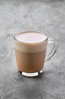 Transparent cup of cappuccino with foam