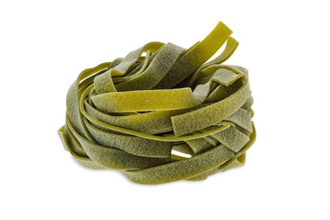 Nest noodles isolated on white background. Italian tagliatelle with spinach
