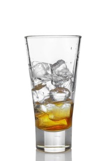 Highball glass with ice and whiskey isolated on white