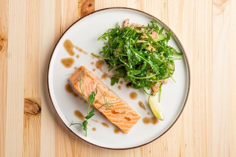 Steamed salmon with arugula and shrimps garnish