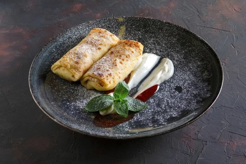 Thin pancakes with curd and sour cream