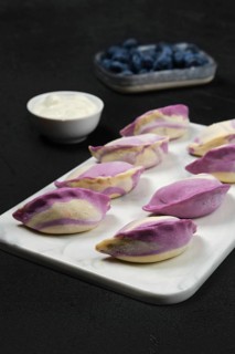 Frozen pierogi with blueberry and sour cream